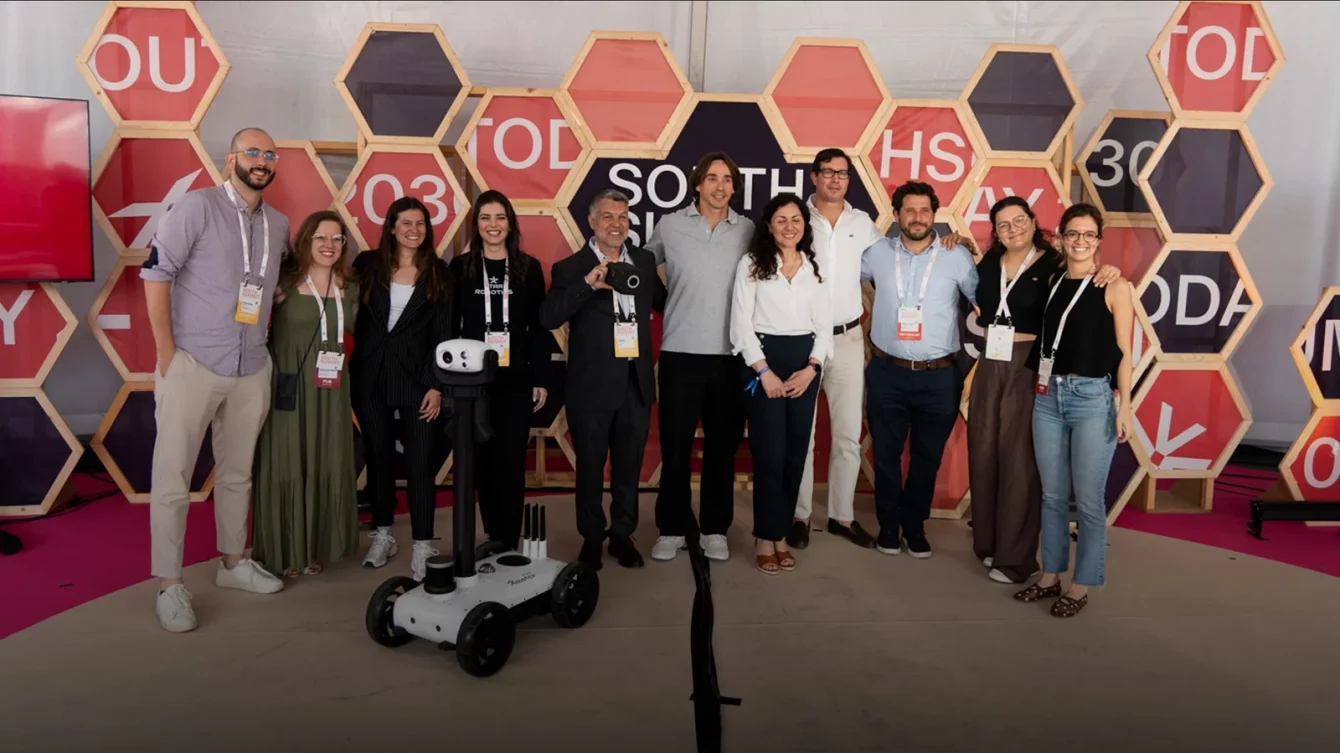 Star Robotics posing with the Watchbot robot at their South Summit Converge 2025